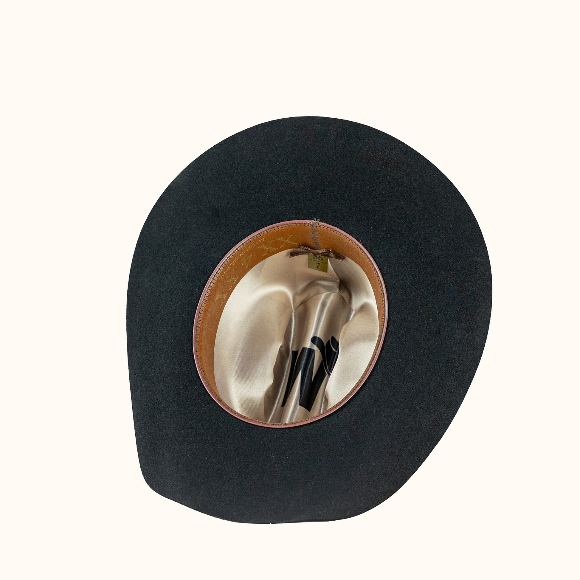 Black hat with a brown rim on a white background