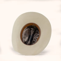 Beige cowboy hat with brown interior and leather sweatband on a white background