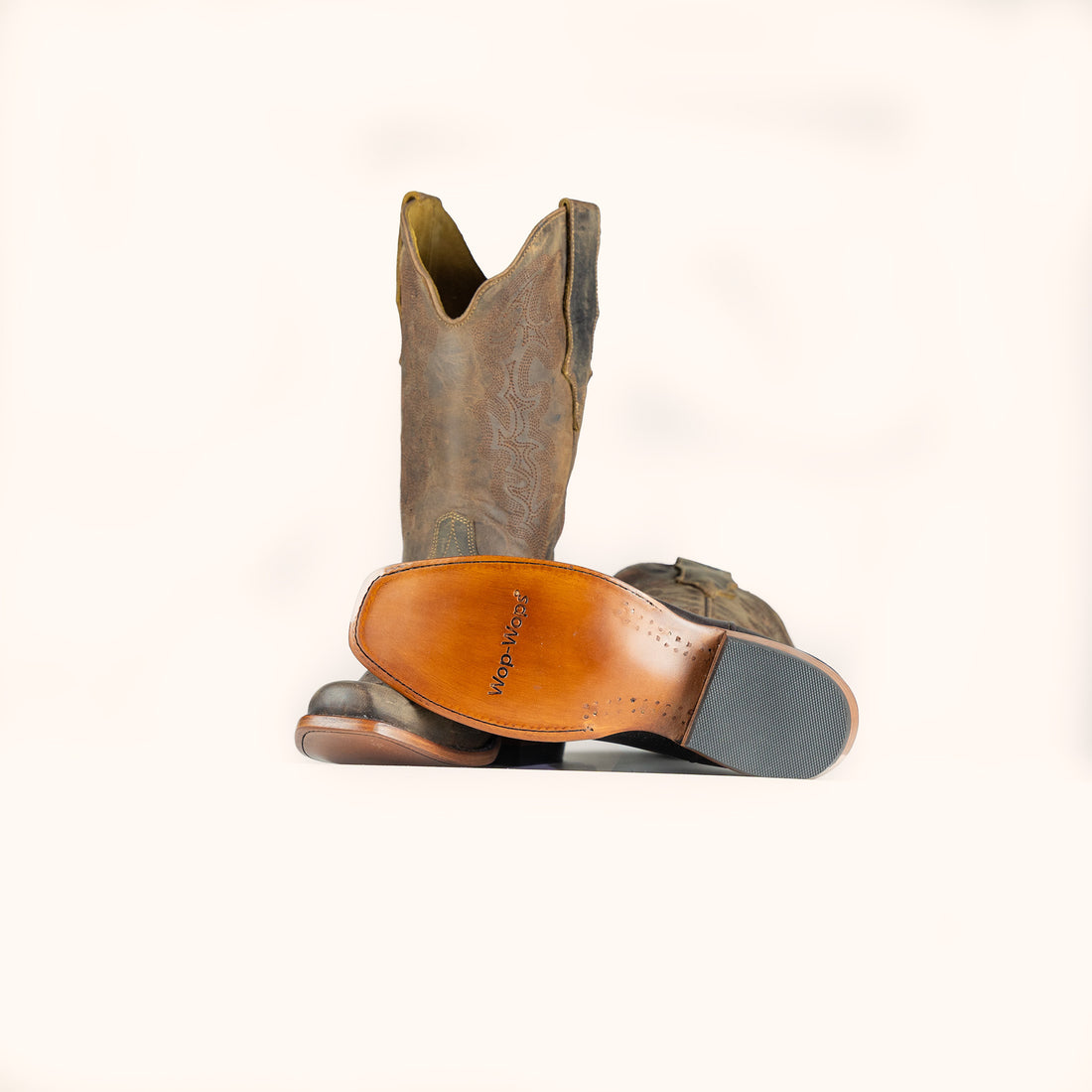 Brown leather cowboy boot on a white background