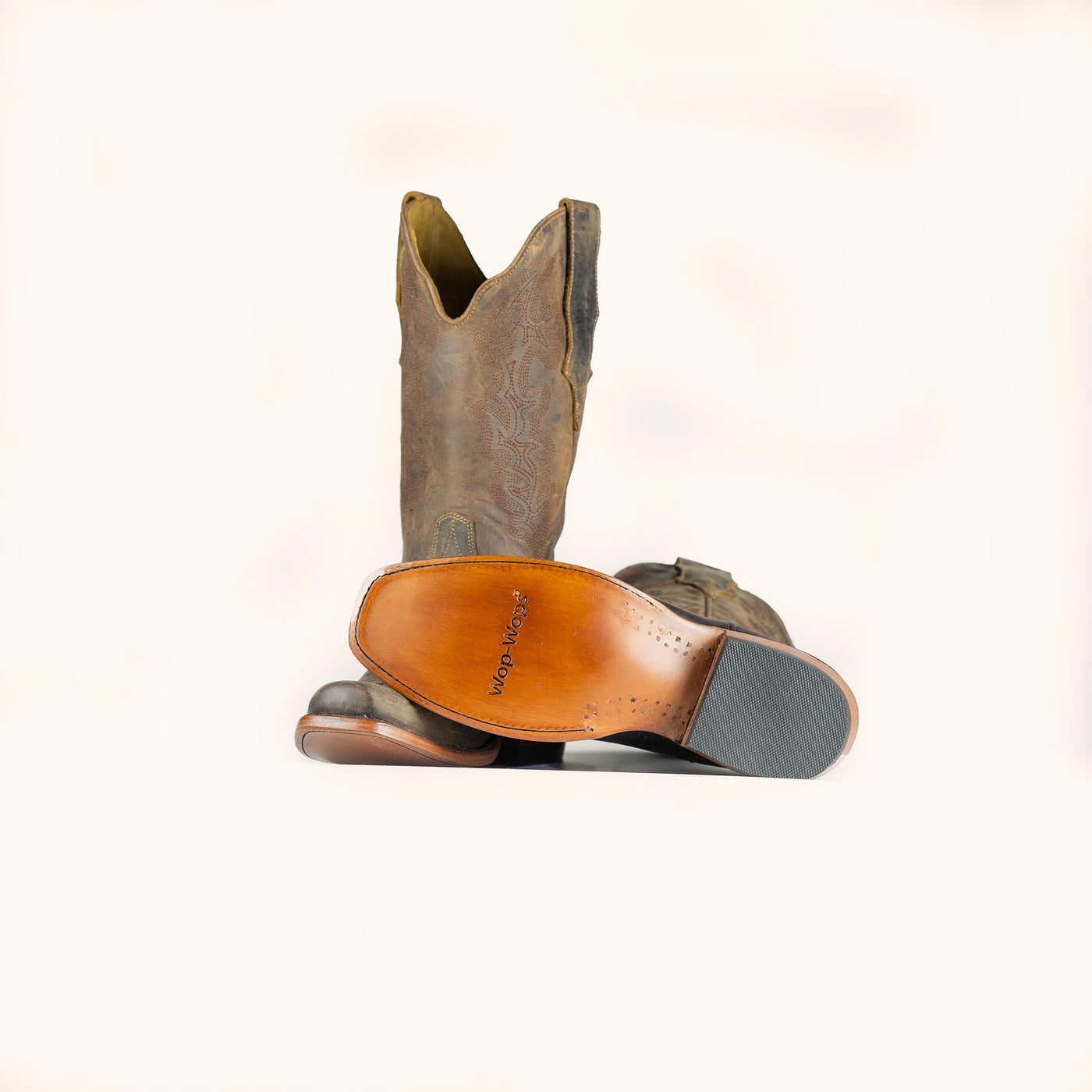 Brown cowboy boot with a visible brand logo on a white background
