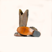 Brown cowboy boot with a visible brand logo on a white background